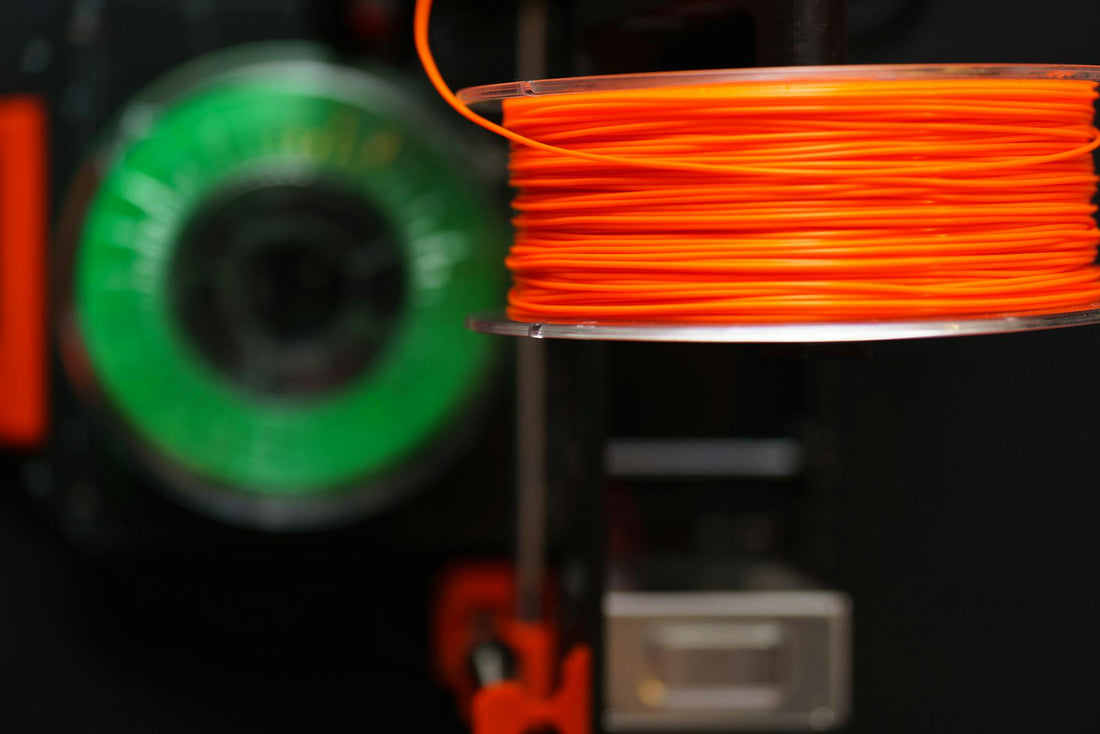 Close-up of colourful 3D printer filament spools in a workshop