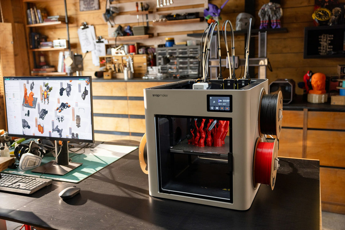 3D printer producing red parts in a workshop with filament spools