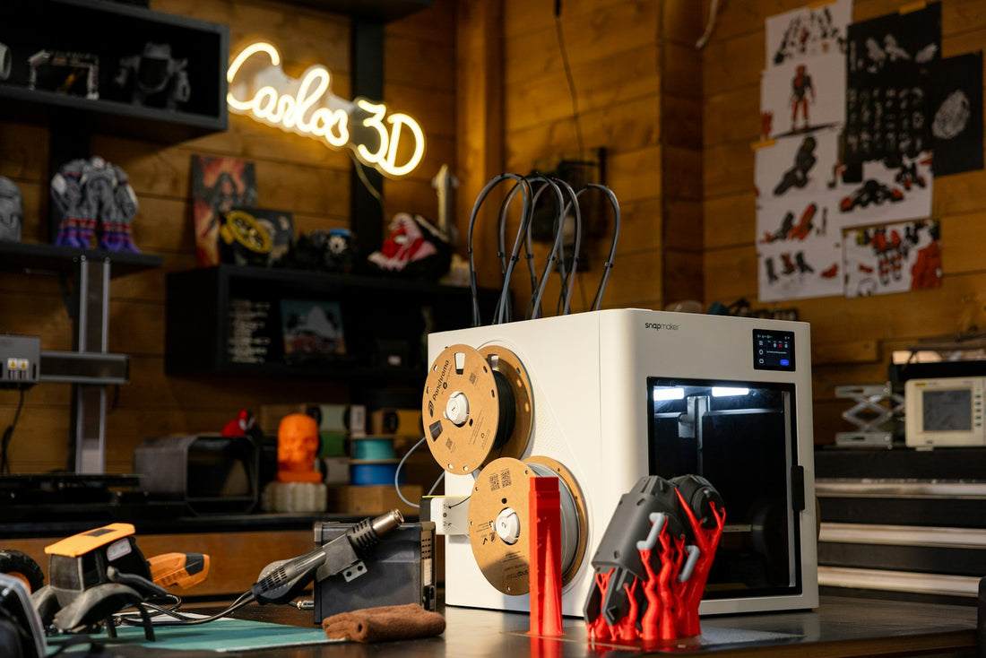 A 3D printer workshop bench with filament spools, tools, and printed parts